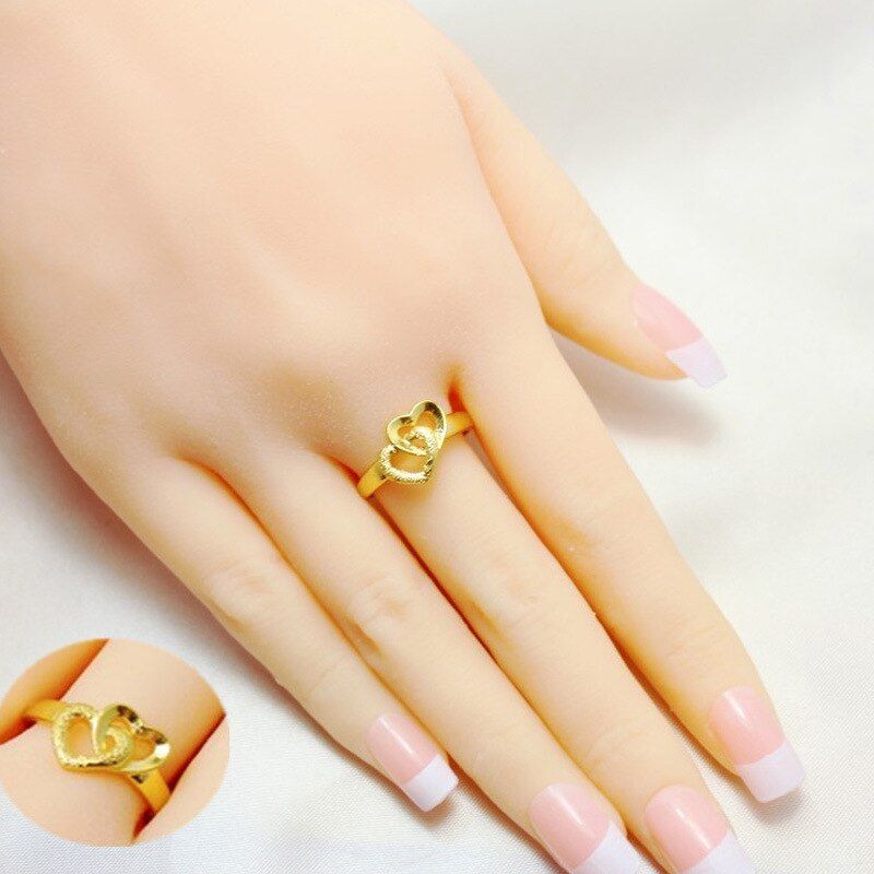 Elegant gold ring worn on a woman’s hand with a minimalist design